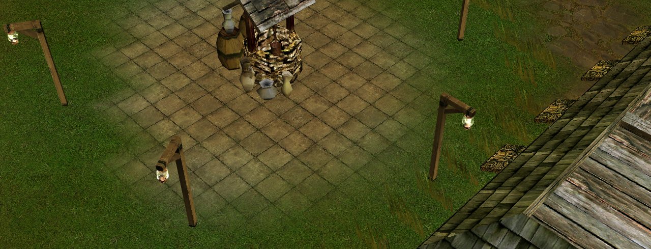 The caravan town of Promiseland: a stone well on a paved square, with lanterns around it